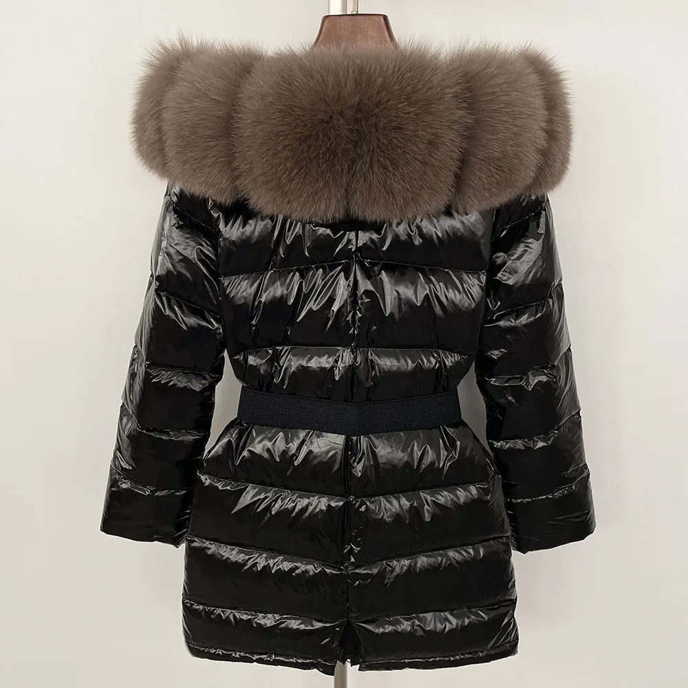 Black puffer jacket with a large fur hood on a mannequin against a white background