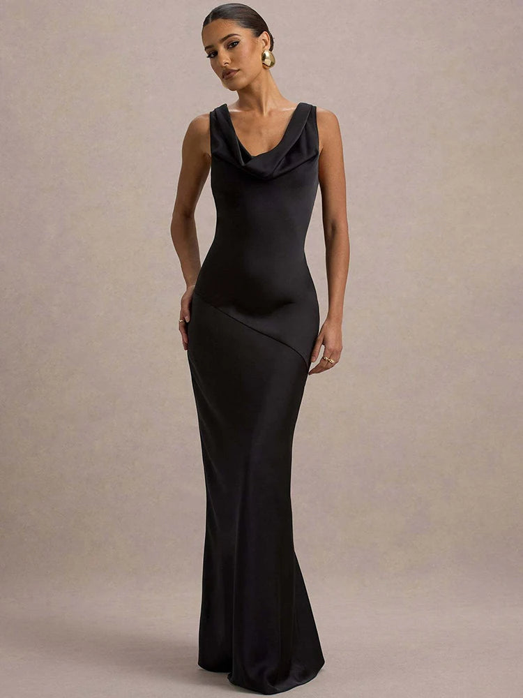Woman wearing a black evening gown against a neutral background