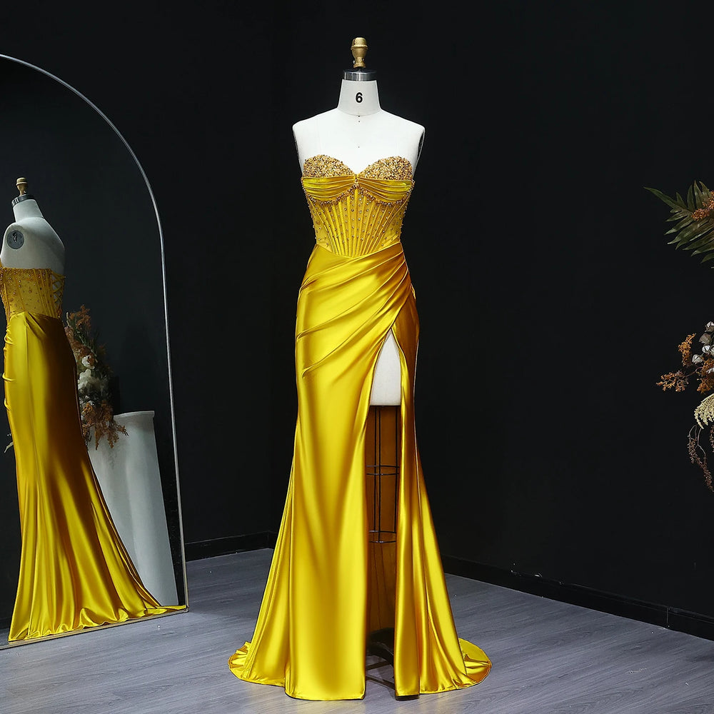 Yellow evening gown on a mannequin against a black background
