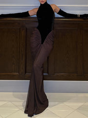 Turtleneck sleeveless draped ruched maxi dress against wood paneling