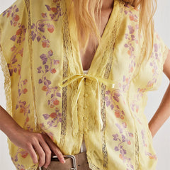 Yellow floral kimono-style garment with a plain background