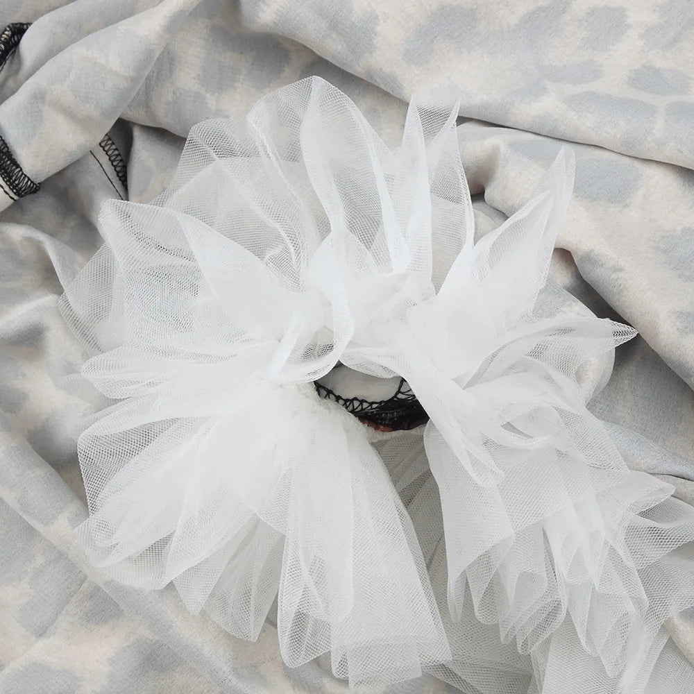 White tulle fabric on a textured gray background