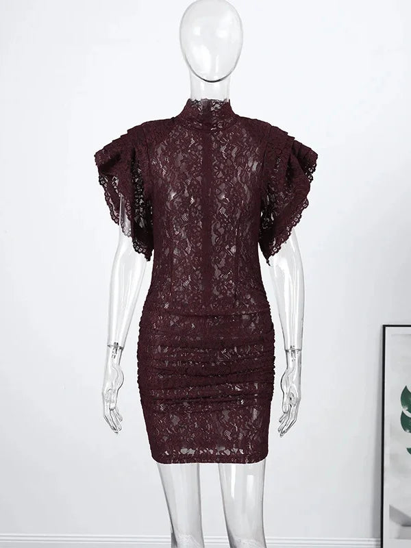 Mannequin wearing a dark lace dress against a white background