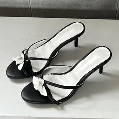 Black and white flower embellished thin heel mules