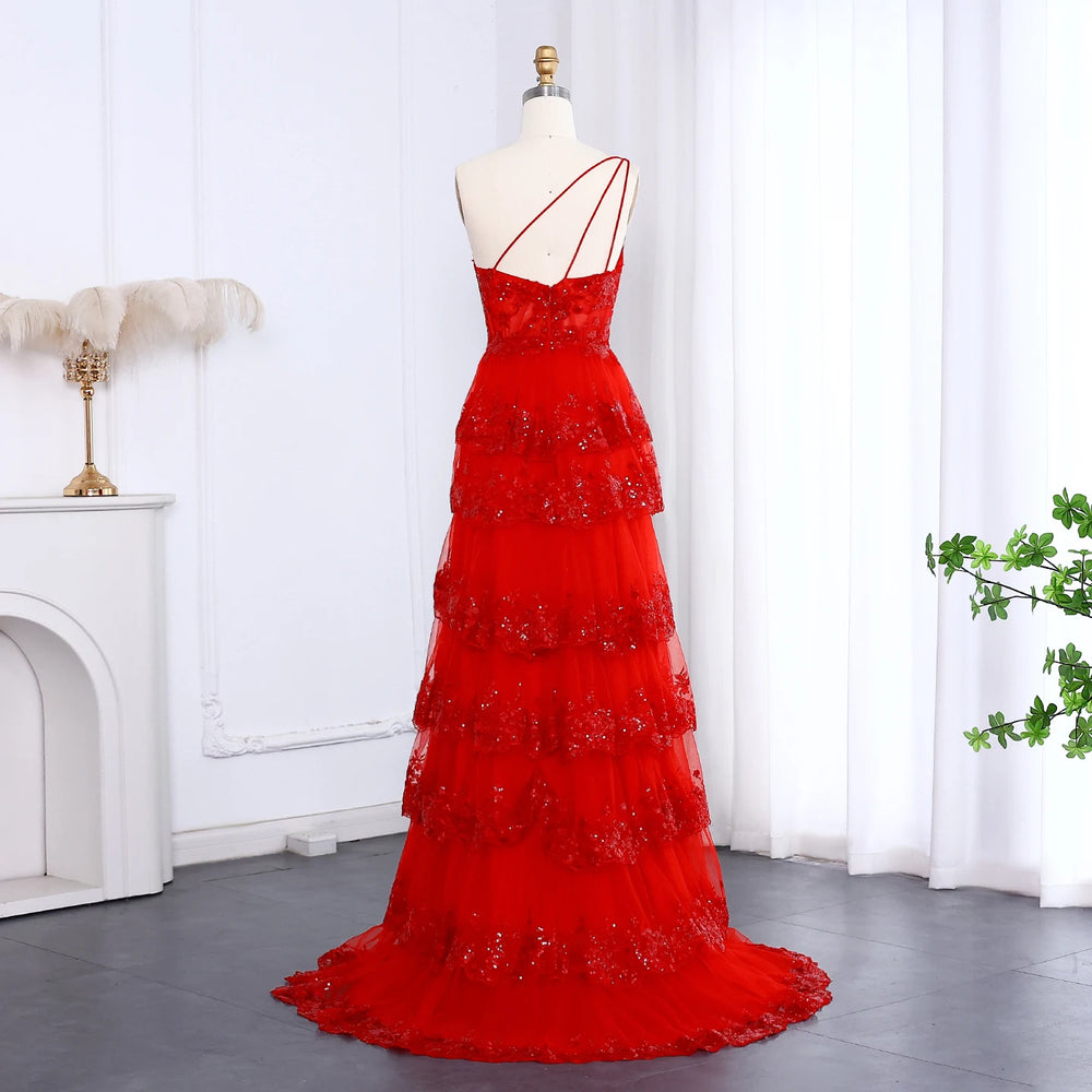 Red evening gown on a mannequin against a white curtain background