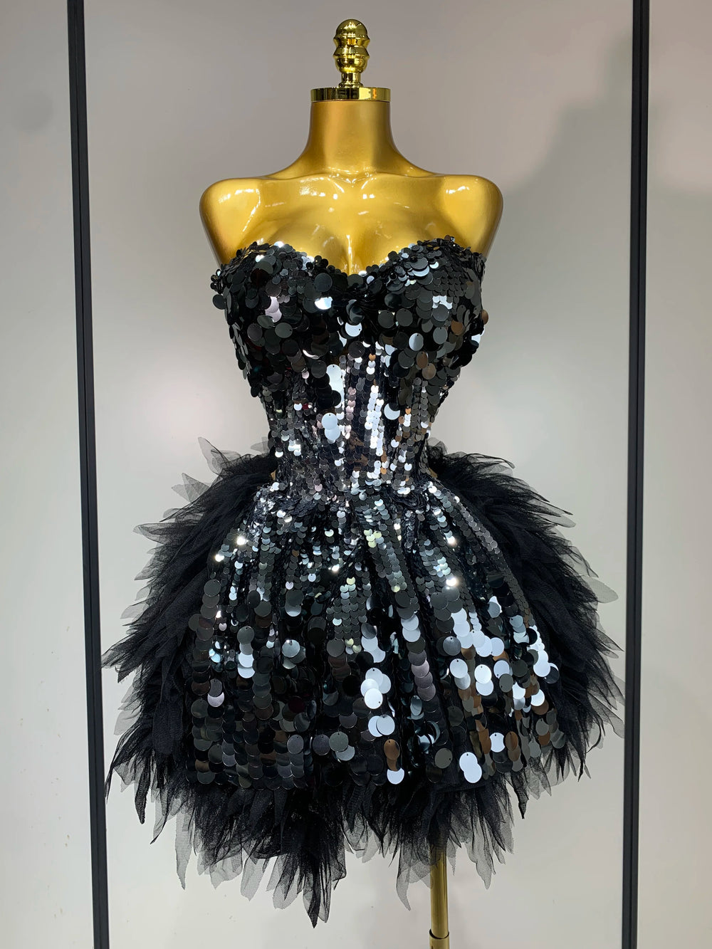 Black strapless sequin and feather mini dress