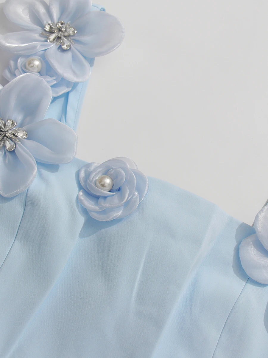 Light blue fabric with floral embellishments on a white background