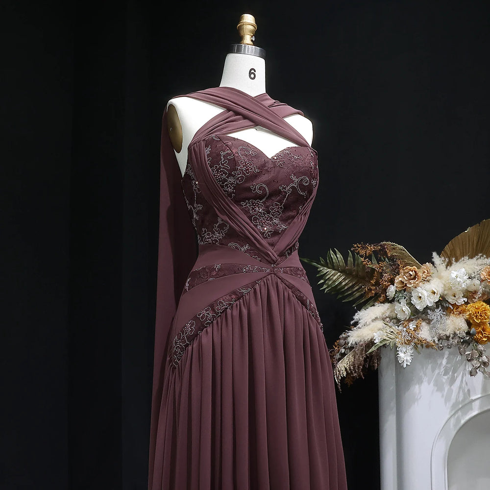 Close-up of the embroidered bodice and halter neckline of a chiffon evening dress.