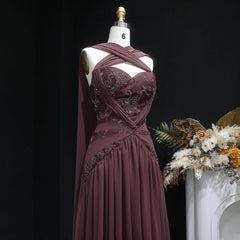 Close-up of the embroidered bodice and halter neckline of a chiffon evening dress.