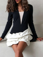 Black V-neck mini dress with sculpted white puff hem