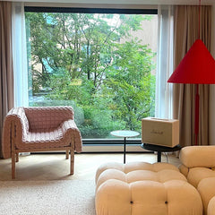 Designer accent chair beside arched decor and minimalist flooring
