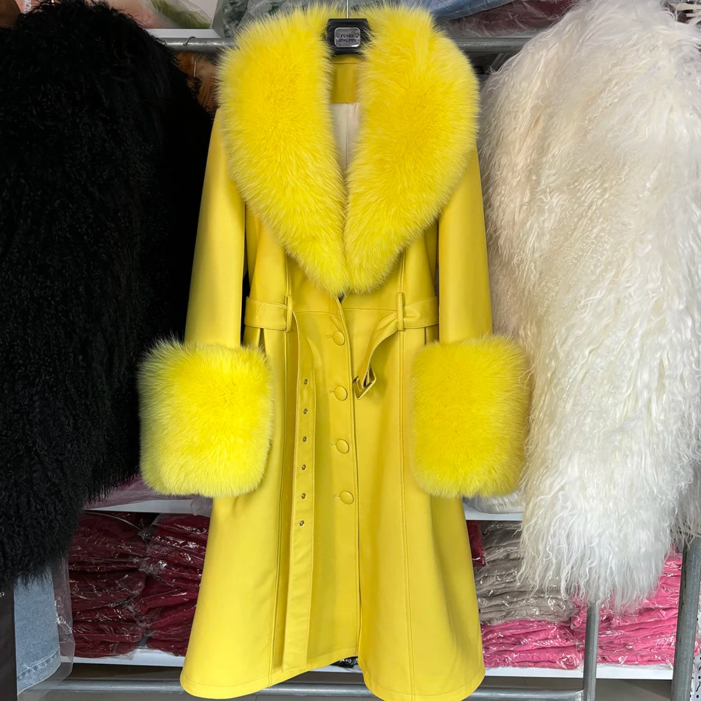 Yellow coat with fur trim hanging on a rack with other coats.