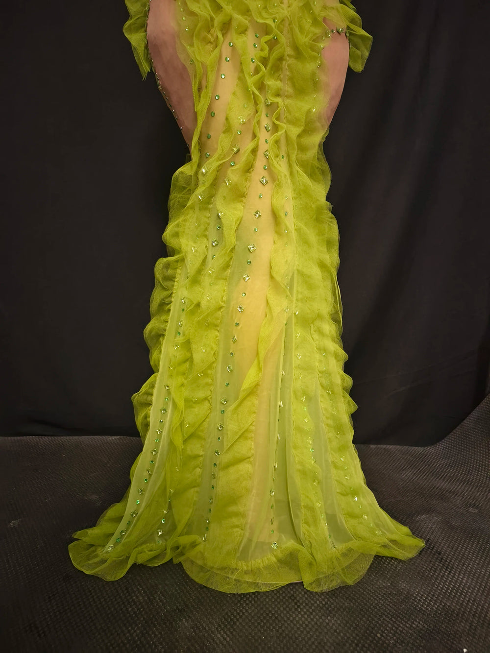 Yellow evening gown with a plunging neckline on a dark background