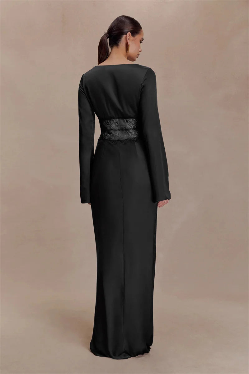 Woman wearing a long black dress against a beige background