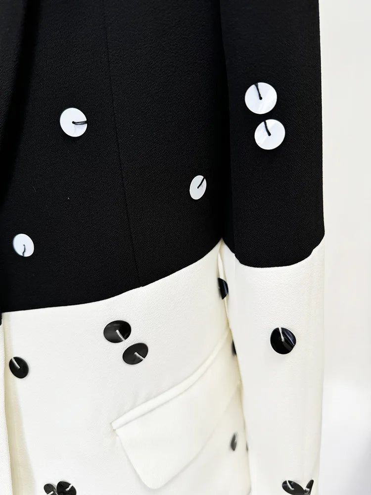 Close-up of a black and white outfit with button details