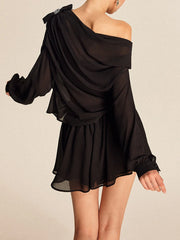 Black one-shoulder dress on a beige background