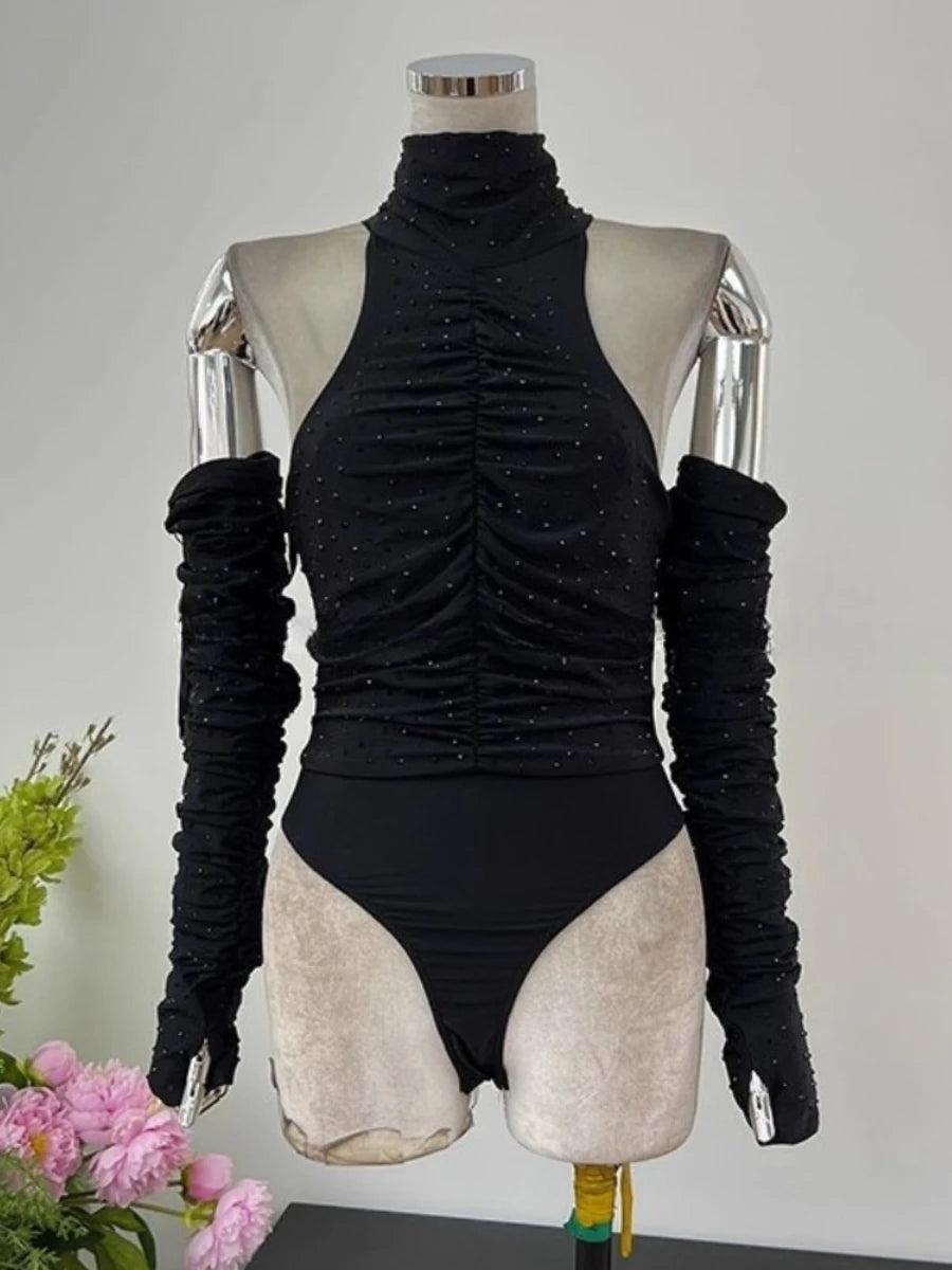 Black ruched bodysuit with long sleeves on a mannequin against a neutral background