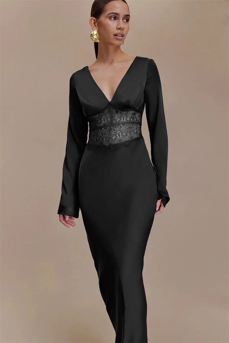 Woman wearing a black dress with a lace waistband against a beige background