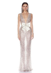 Front view of a silver sequined V-neck gown with a large white bow.