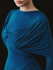 Blue dress with draped design on a black background
