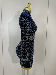 Mannequin wearing a navy blue dress with white rhinestone pattern against a white background