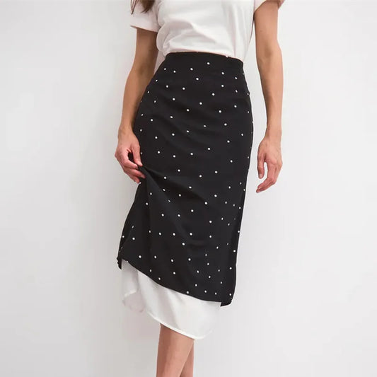 Close-up of a polka dot midi skirt's fabric and layered hem.