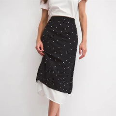 Close-up of a polka dot midi skirt's fabric and layered hem.