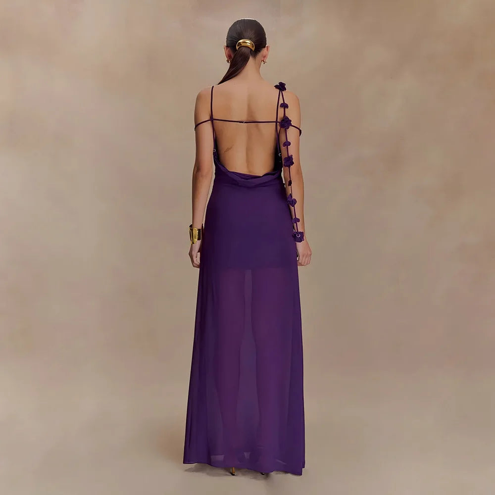 Woman wearing a long purple dress with a plain background