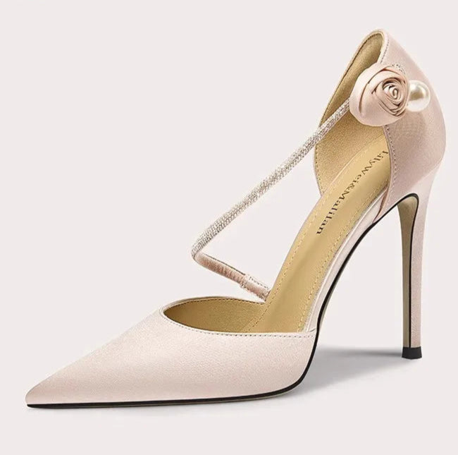 High-heeled shoe with a decorative strap on a white background