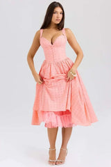 Woman wearing a pink dress on a white background
