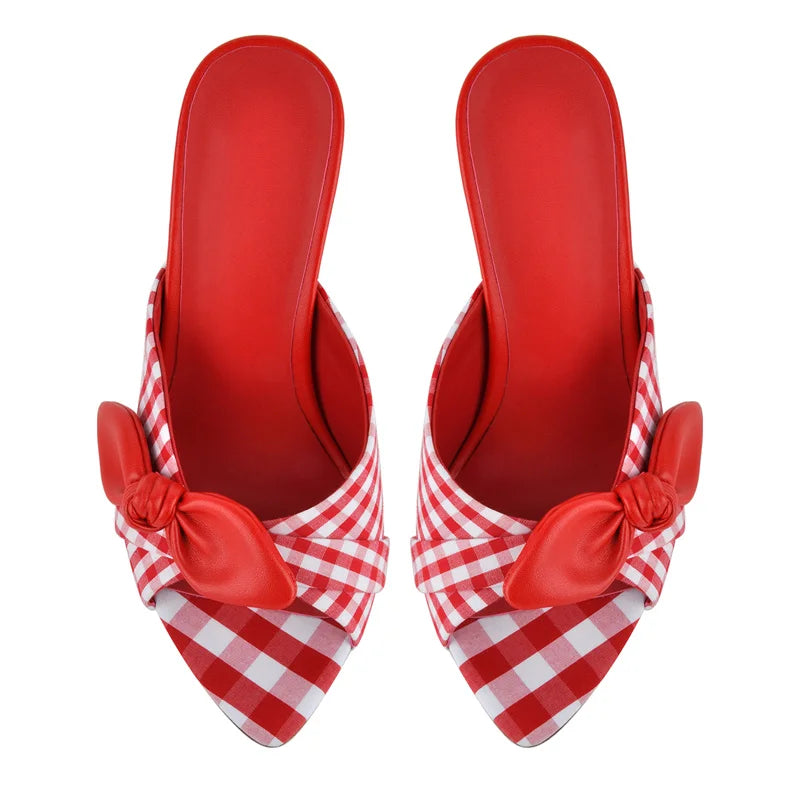 Top view of red and white gingham mules with bow accents.