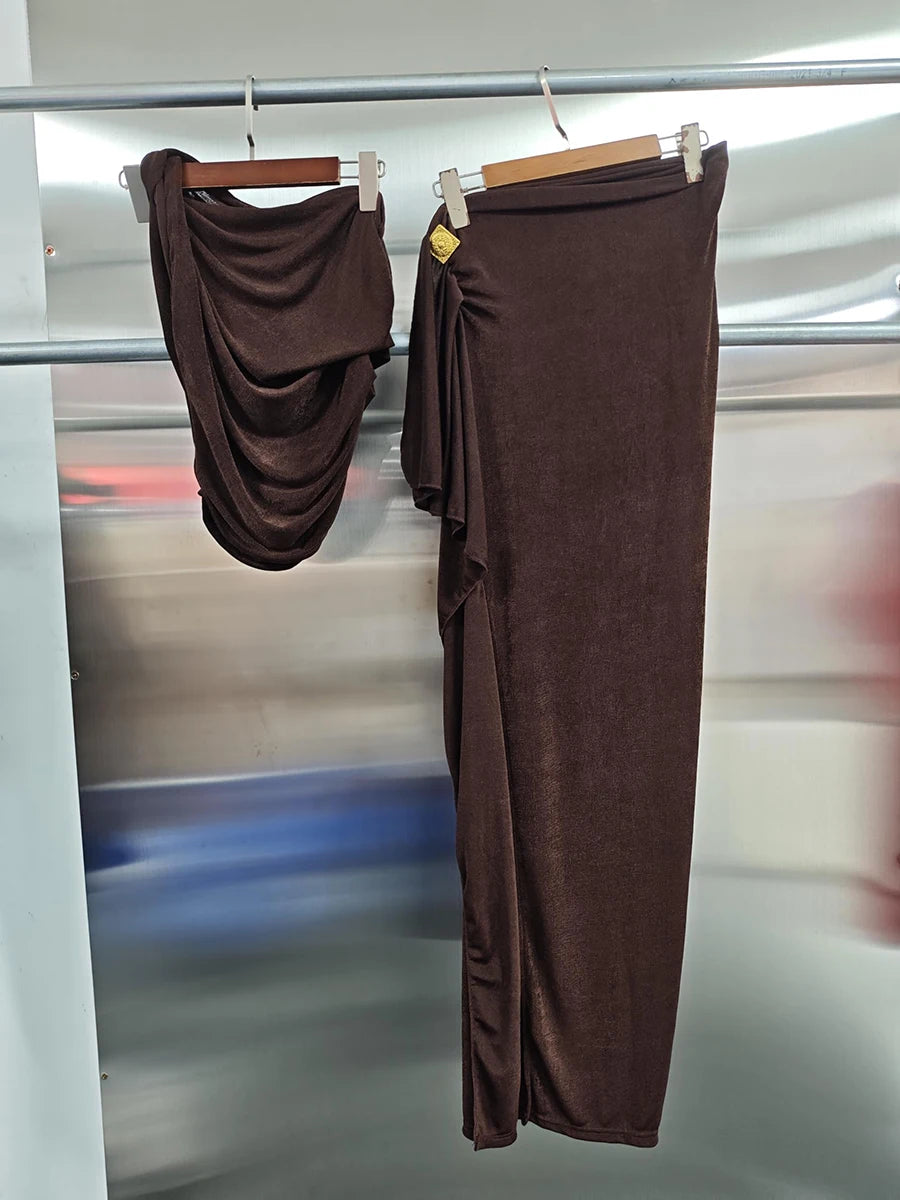 Brown pants on hangers against a reflective surface