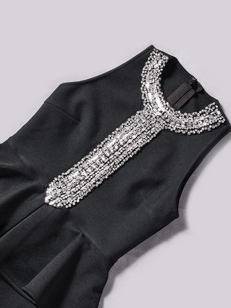 Black dress with silver embellishments on a light gray background