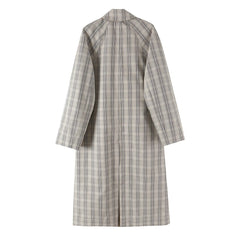 Back view of a reversible coat in plaid pattern.