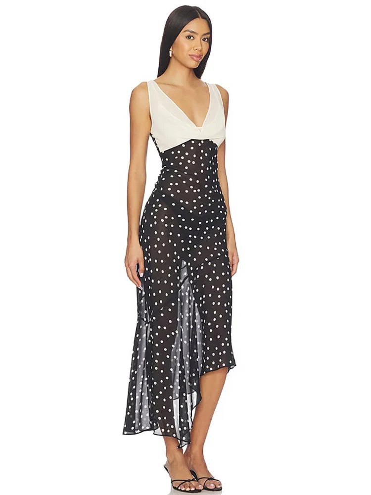 Side view of a contrast panel polka dot maxi dress.