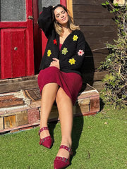 Person wearing a floral appliqu� knit cropped cardigan outdoors