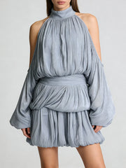 Blue dress with long sleeves and a belt on a plain background