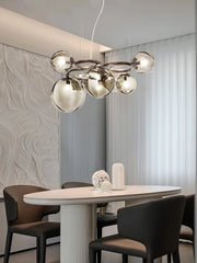 Lifestyle image showcasing the Nordic chandelier as a sophisticated statement piece in a contemporary dining room. Golden Atelier 4