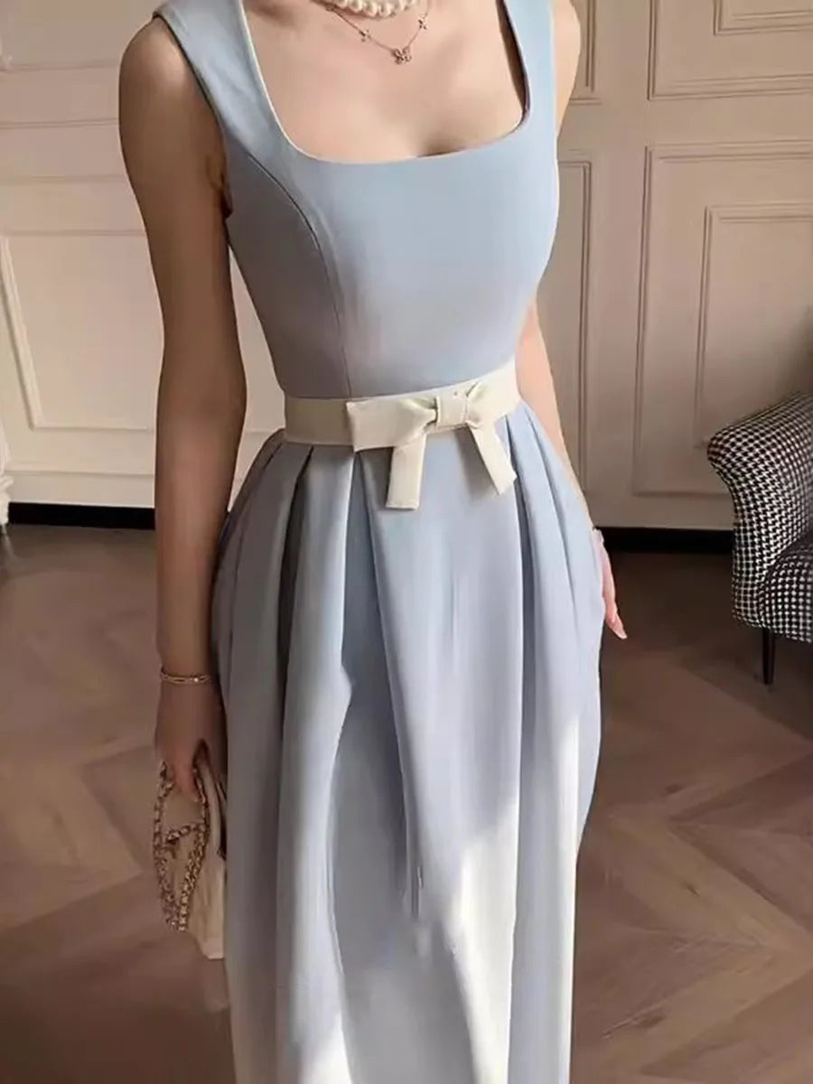 Light blue dress with a white belt worn by a person indoors.