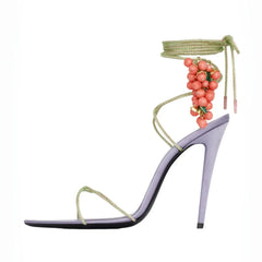 Side view of a purple stiletto sandal with coral grape bead embellishments and ankle wrap