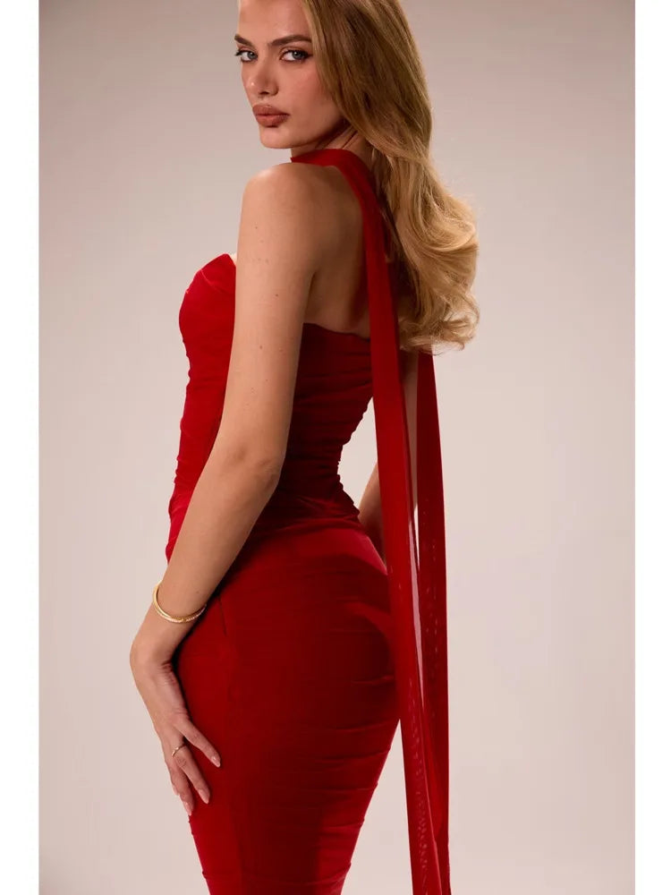 Woman wearing a red dress with a plain background