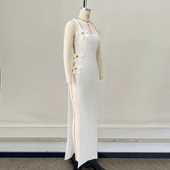 White dress with floral details on a mannequin against a plain background