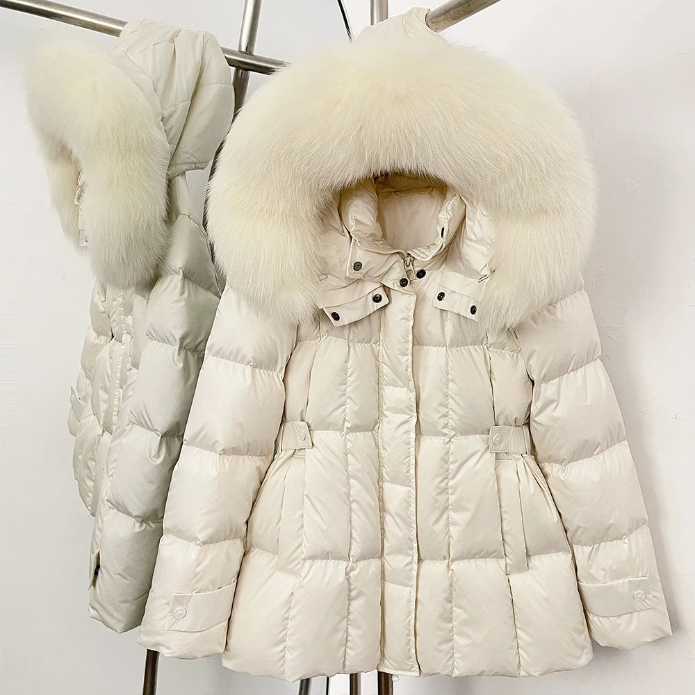 White puffer jacket with fur hood on a rack against a white background