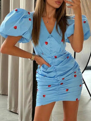 Close-up of a puff sleeve ruched mini dress with a turn-down collar.