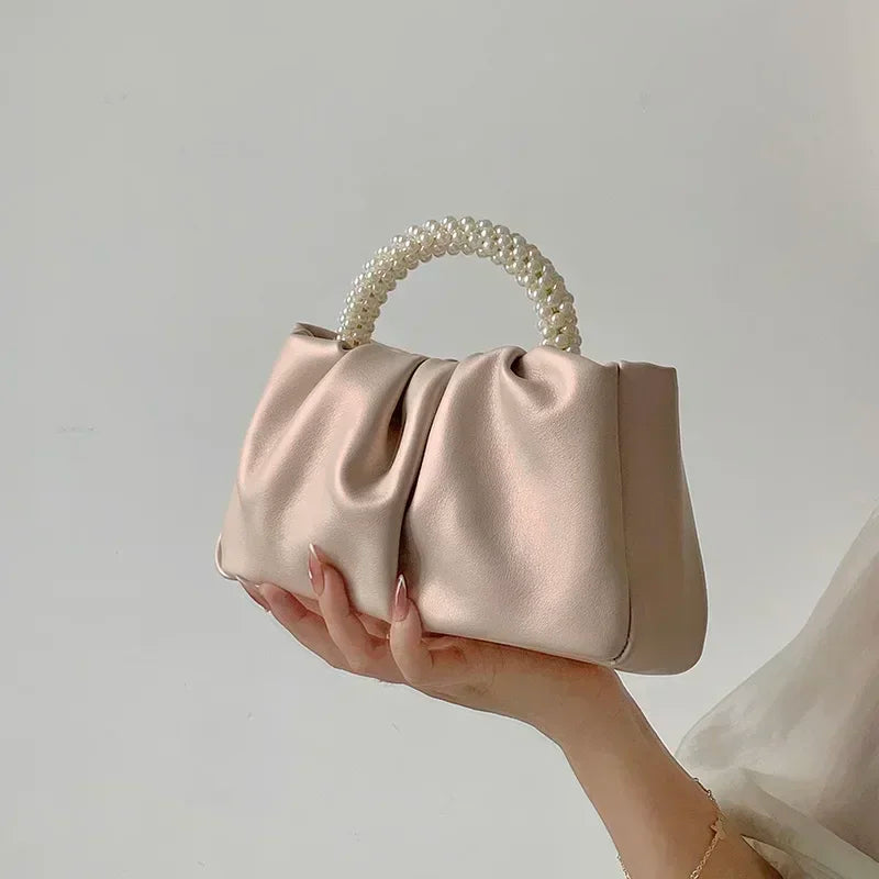Silver and gold gathered clutch bags with pearl handles