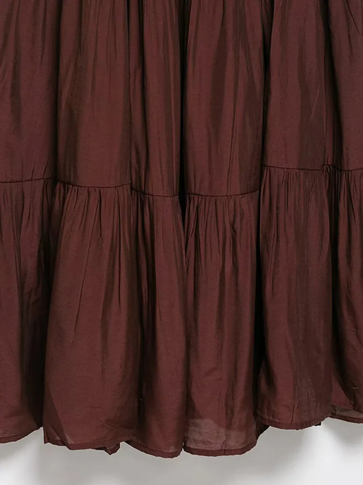 Close-up of a maroon curtain with ruffled layers 