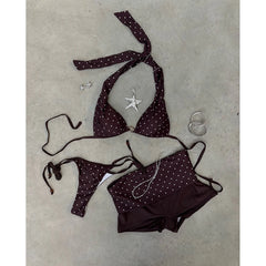 Flat lay of a polka dot bikini and cover-up skirt with accessories