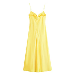 Yellow satin slip dress on a white background