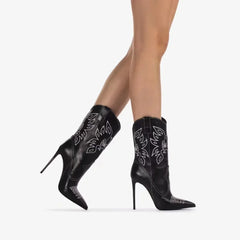 Model wearing black embroidered pointed stiletto cowboy boots