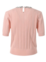Pink sweater with cable knit pattern on a white background